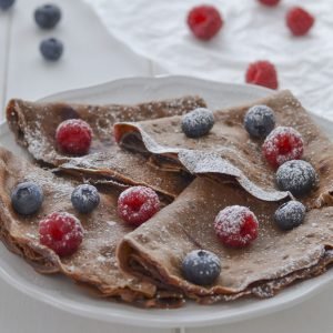 crepes al cacao con frutti di bosco e zucchero a velo
